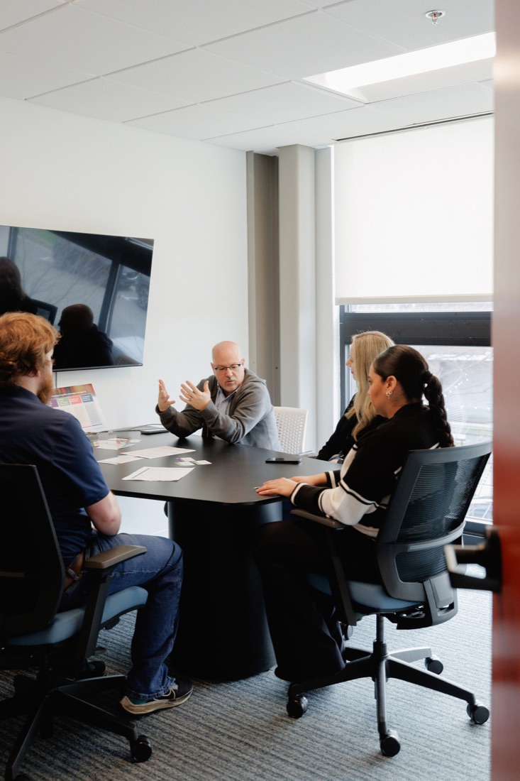 A team meeting in a glass-walled conference room