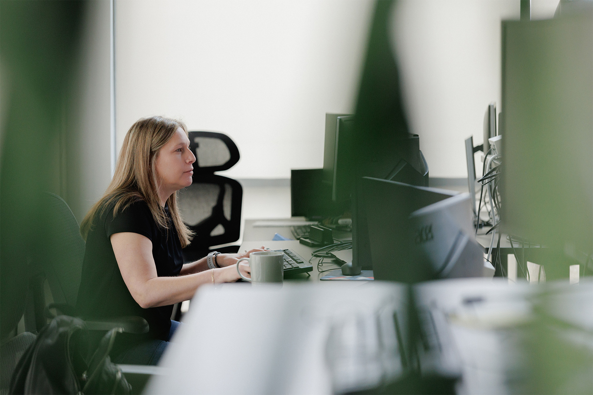 A member of a client's security team reviewing documentation at her desk