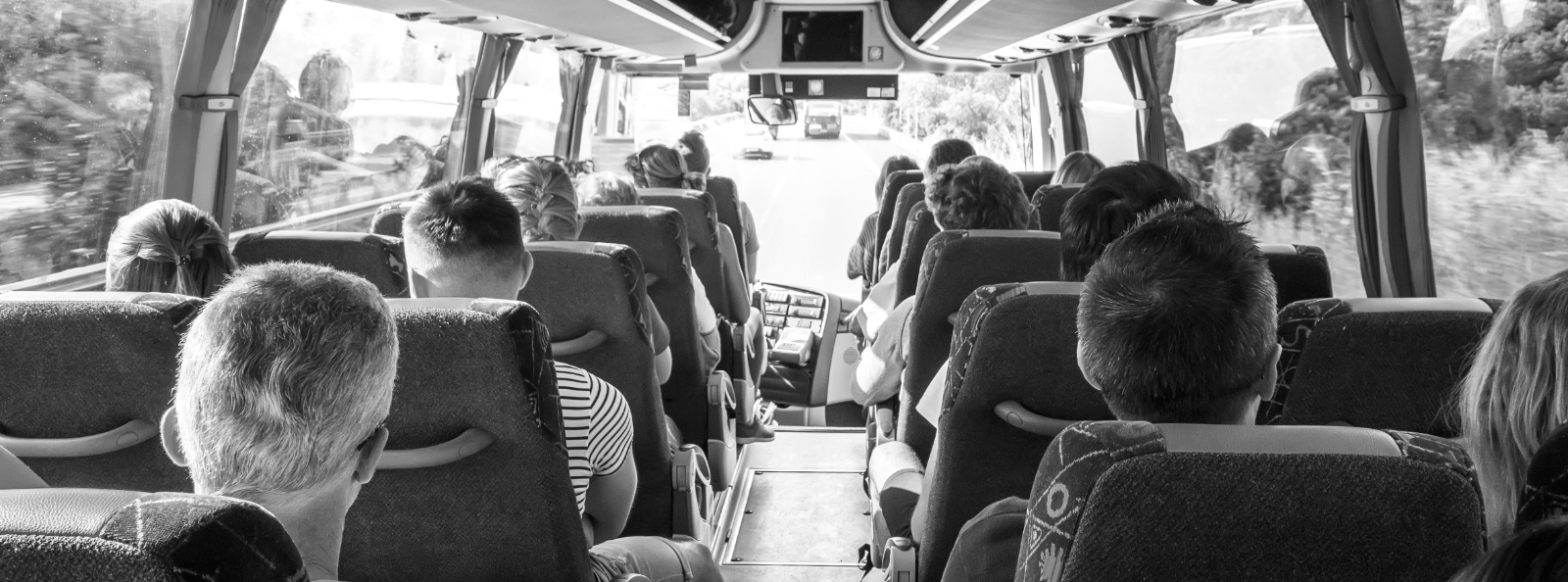 Passengers seated on a tour bus.